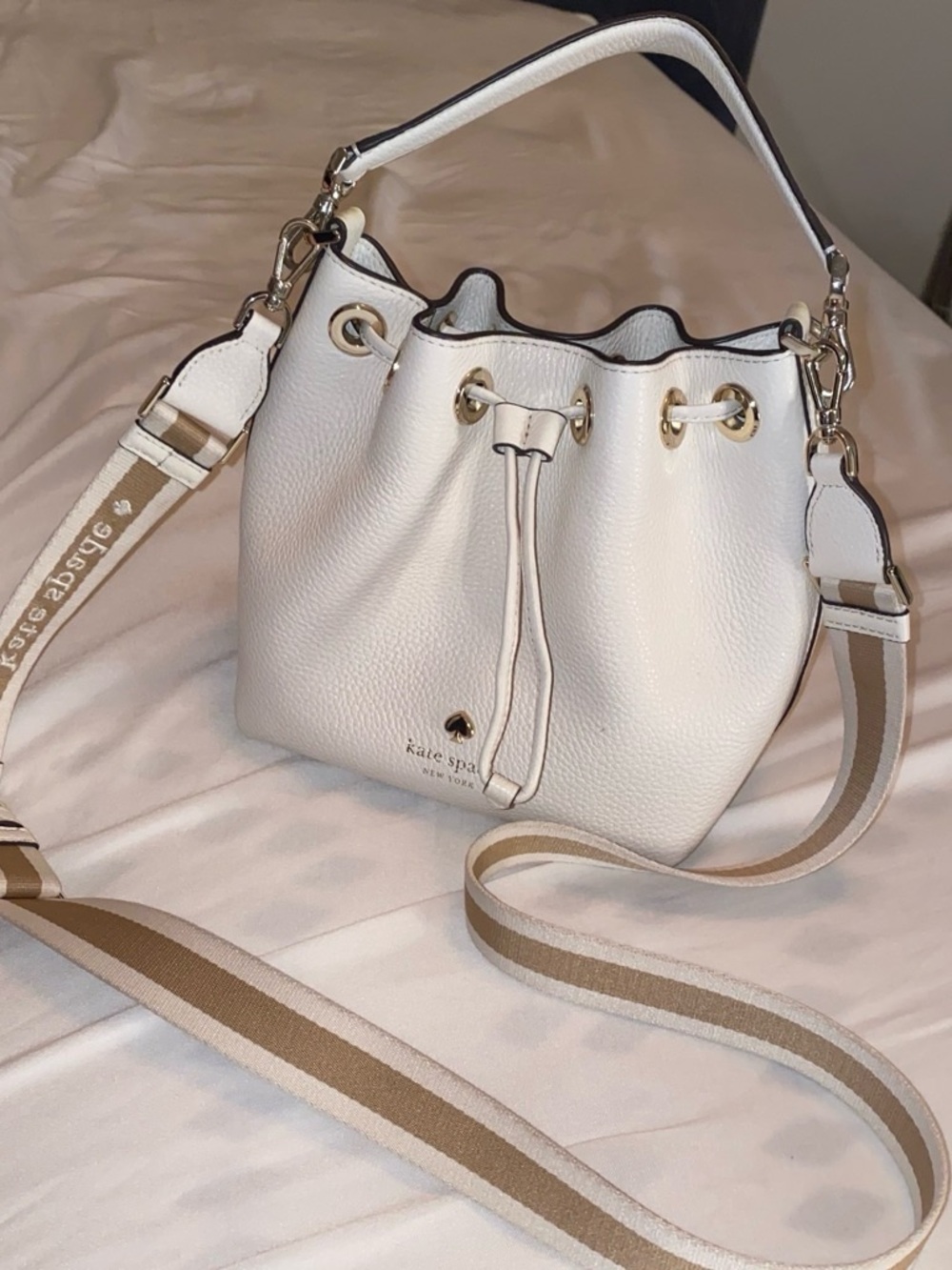 kate spade White Pebbled Leather Drawstring Bucket Bag with Striped Strap